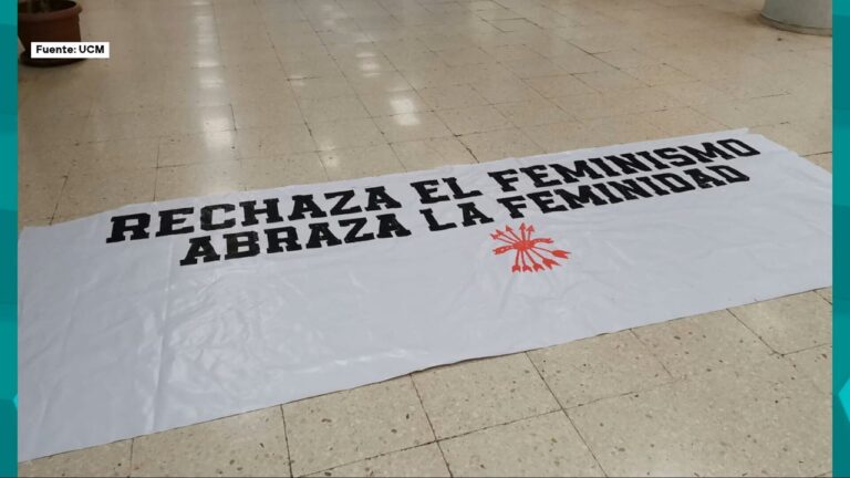 Pancarta blanca desplegada en el suelo de la Universidad Complutense con el mensaje “Rechaza el feminismo, abraza la feminidad” junto a un símbolo de la Falange.